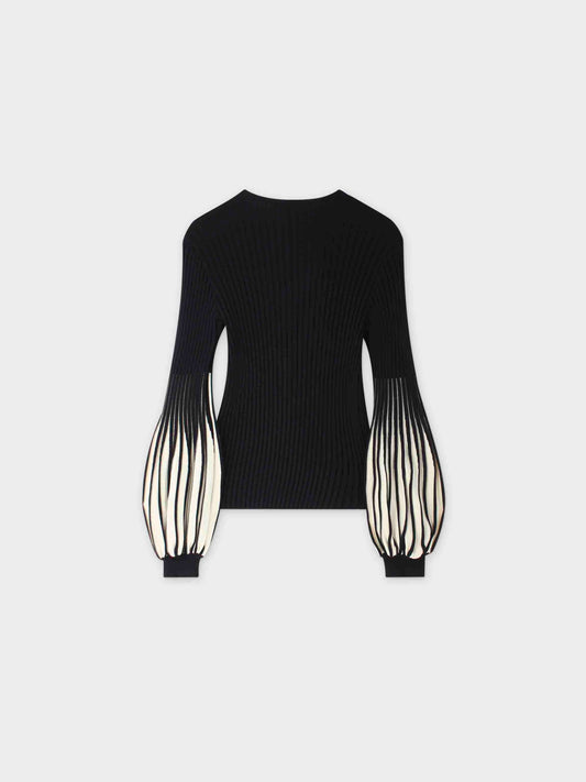 Black ribbed sweater with sheer sleeves on a white background