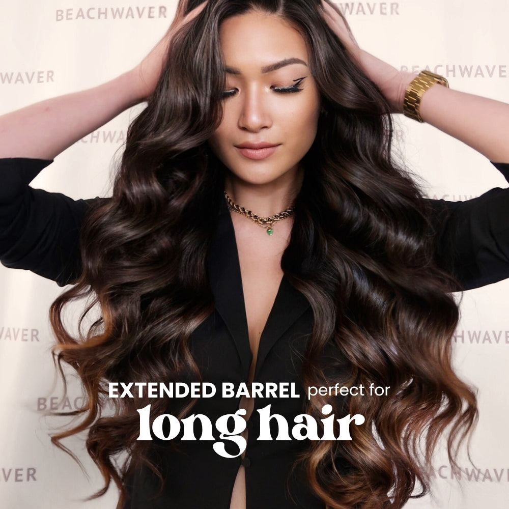 Woman with long, wavy hair styled with 'Extended Barrel' product, wearing a black top.