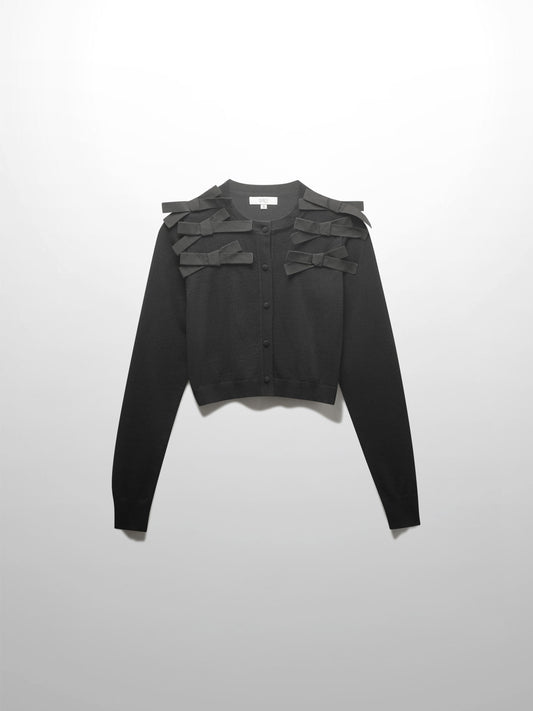 Black long-sleeve top with layered shoulder details on a light gray background