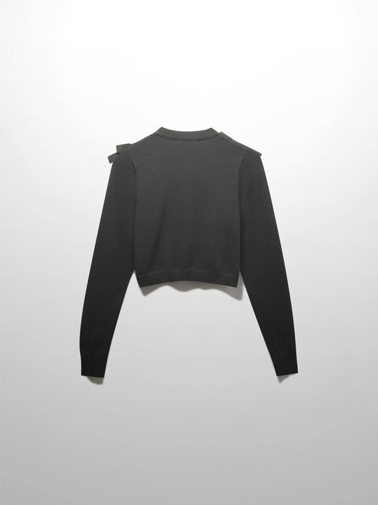 Black long-sleeve top with a bow detail on a white background