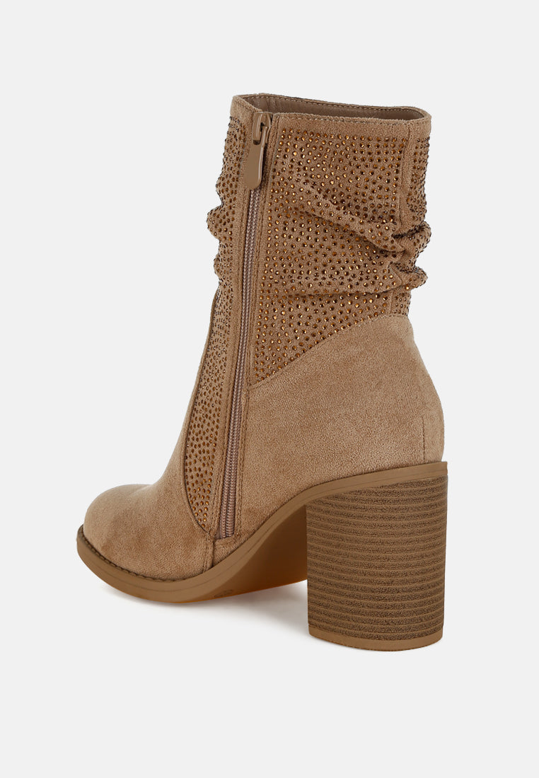 Tan ankle boot with decorative pattern on a white background