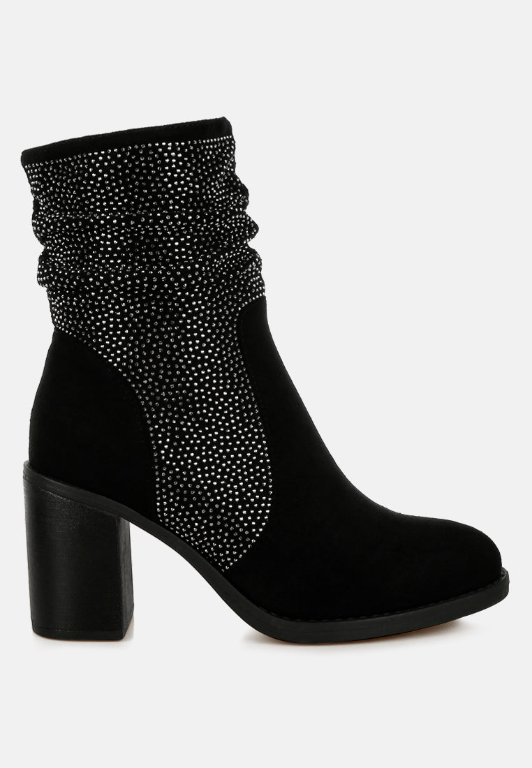 Black ankle boot with rhinestone detailing on a white background