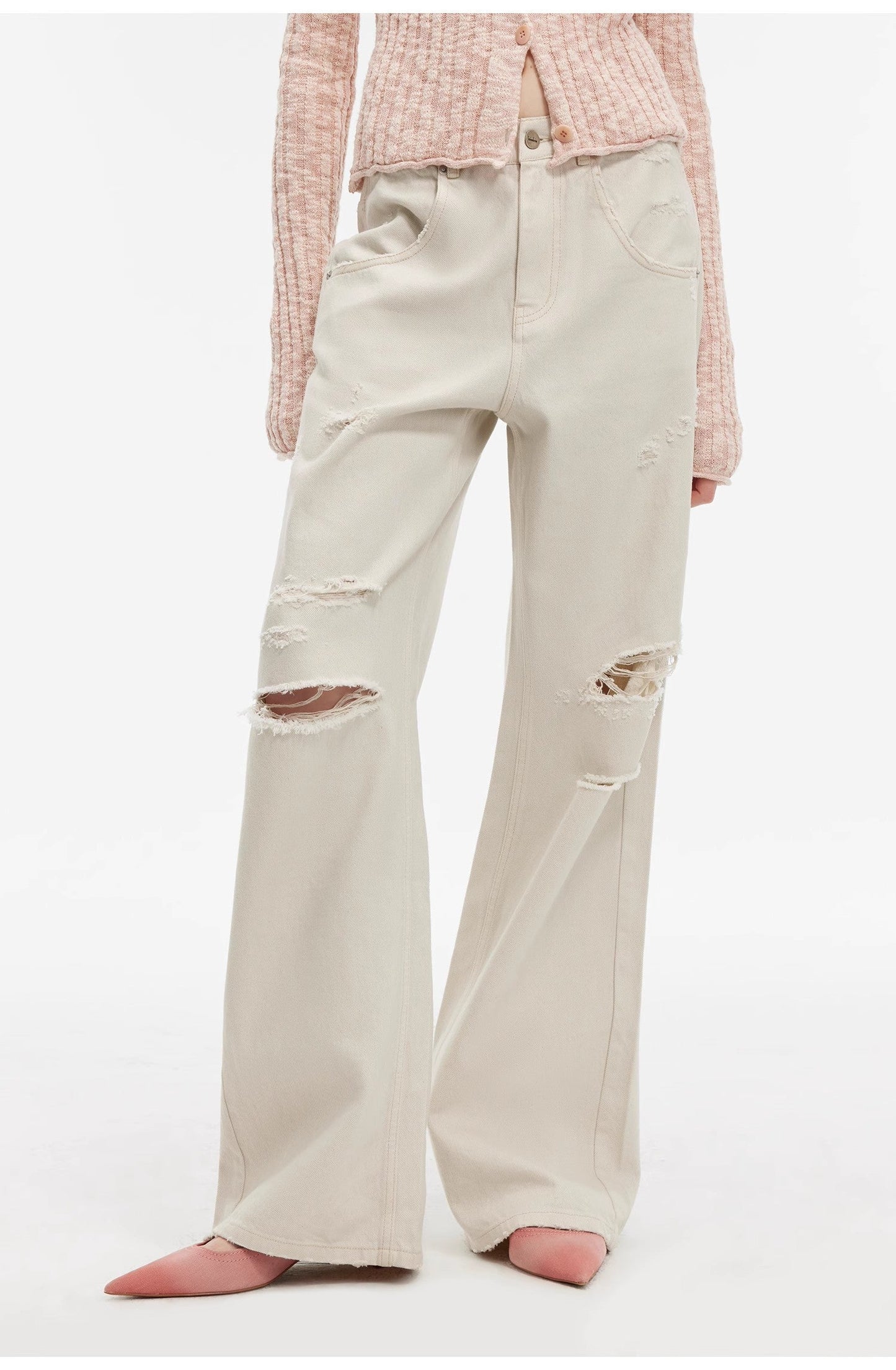 Beige distressed wide-leg jeans worn with a pink checkered shirt on a white background