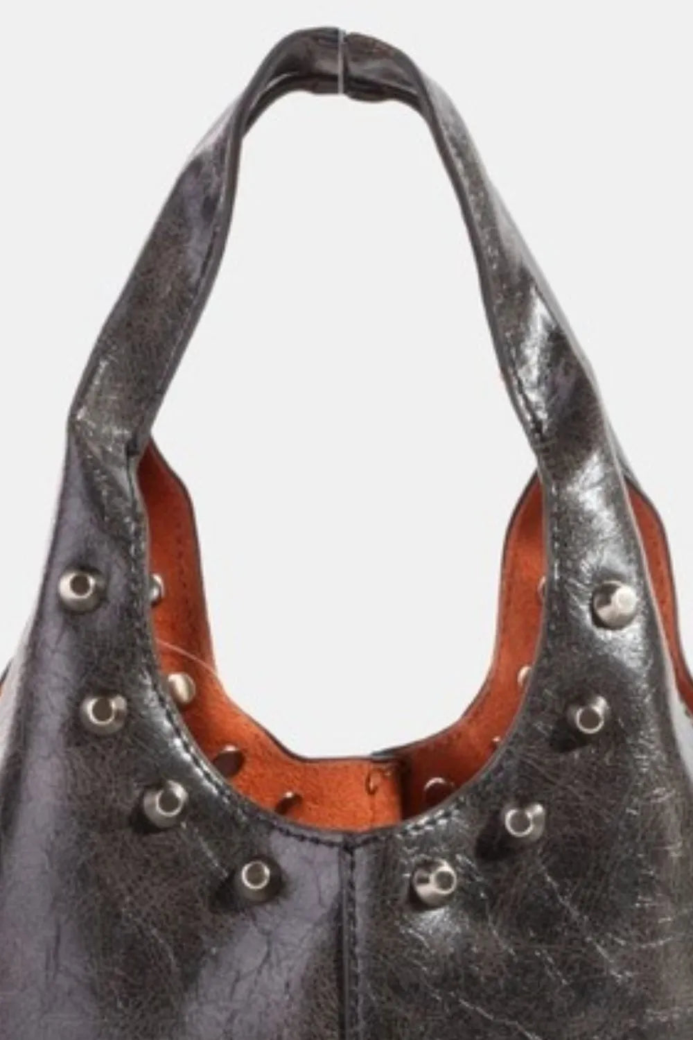 Black leather handbag with studs on a white background