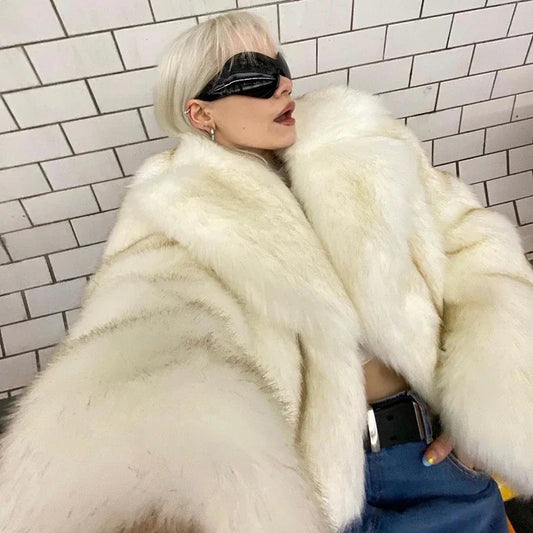 Person wearing a white fur coat and black sunglasses against a tiled wall.