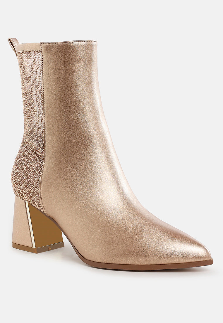 Gold ankle boot with a block heel on a white background