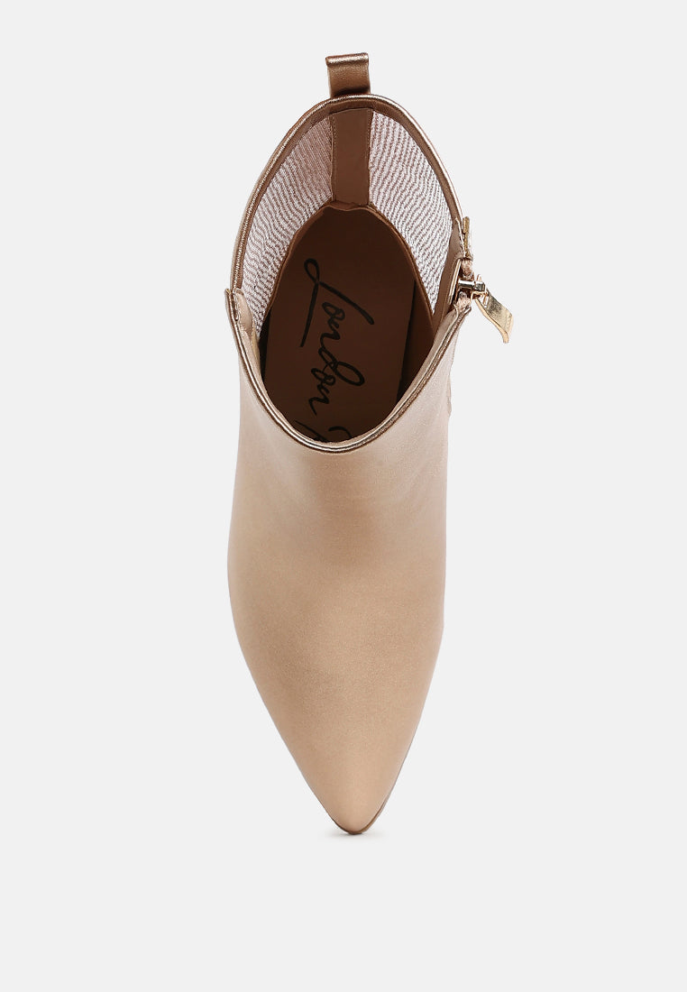 Beige ankle boot with a gold zipper on a white background