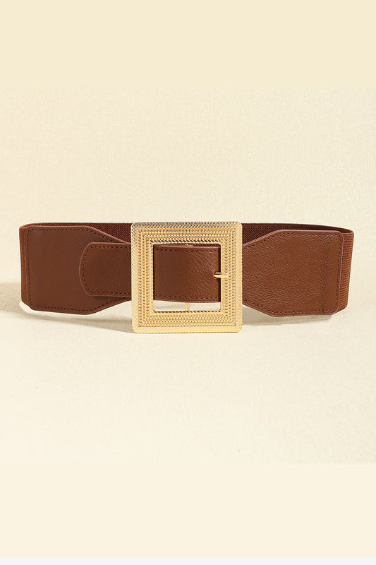 Brown belt with a gold buckle on a beige background
