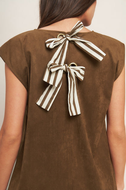 Brown top with striped bow detail on the back against a neutral background