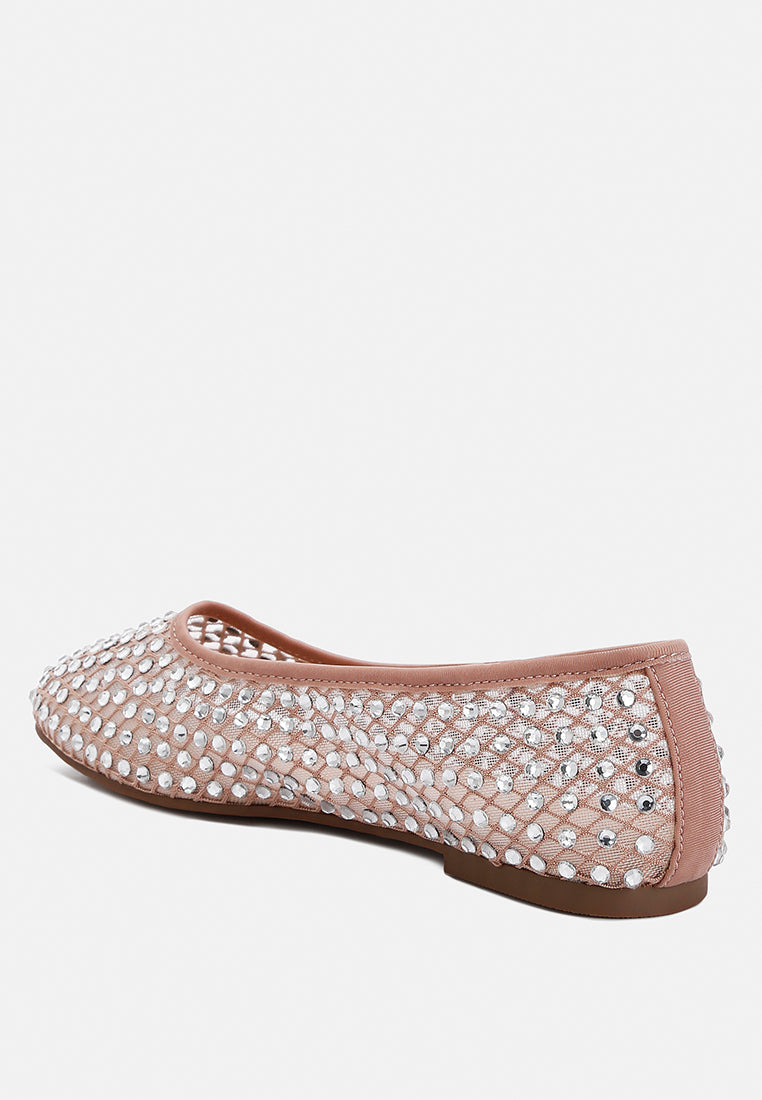 Pink flat shoe with rhinestone embellishments on a white background