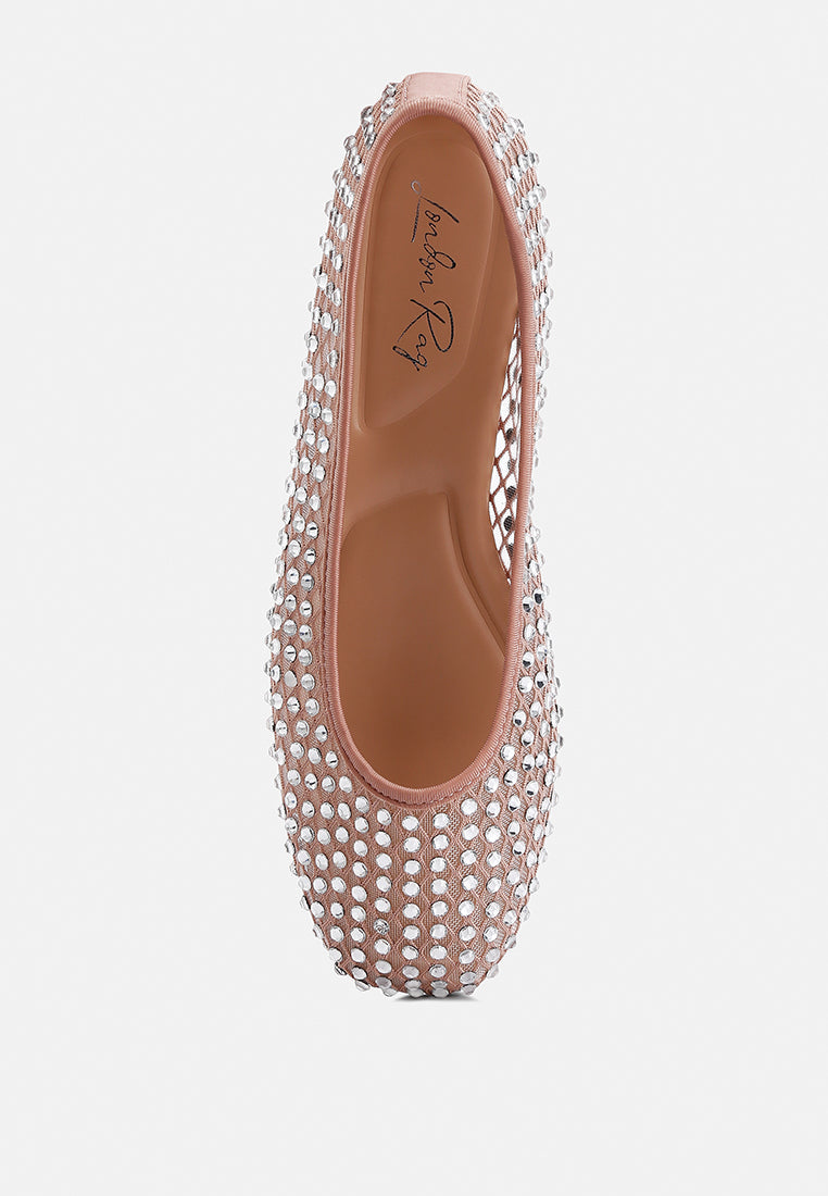 Pink studded flat shoe on a white background