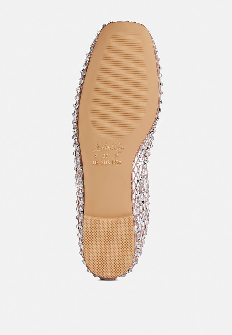 Tan shoe sole with decorative criss-cross pattern on a light gray background