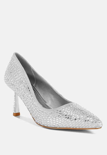 Silver high-heeled shoes with rhinestone embellishments on a white background