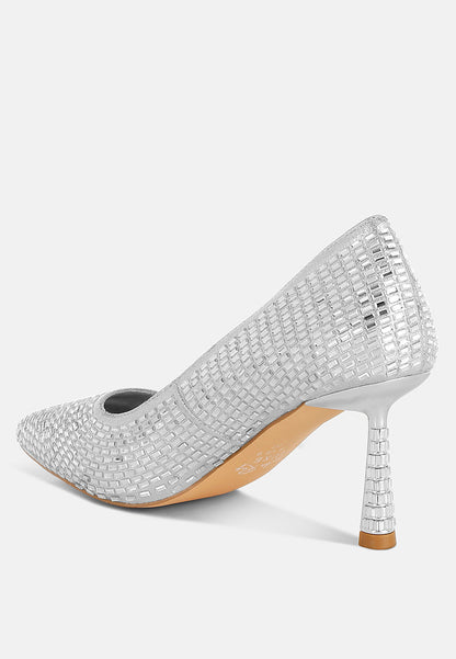 Silver high-heeled shoe with rhinestone embellishments on a white background