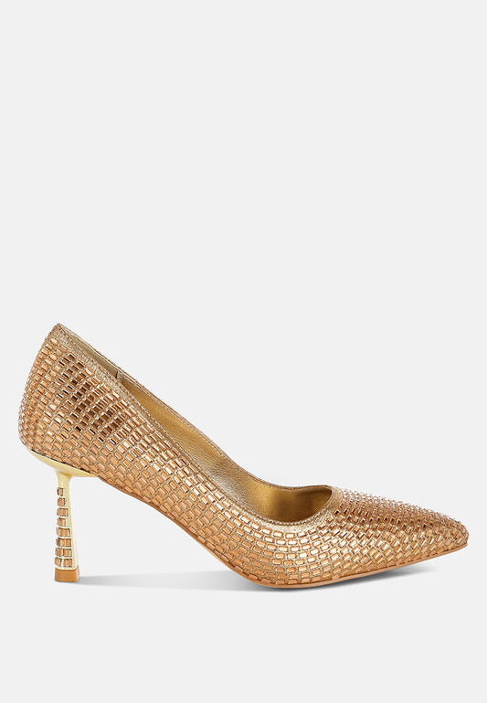 Gold high-heeled shoe with textured design on a white background