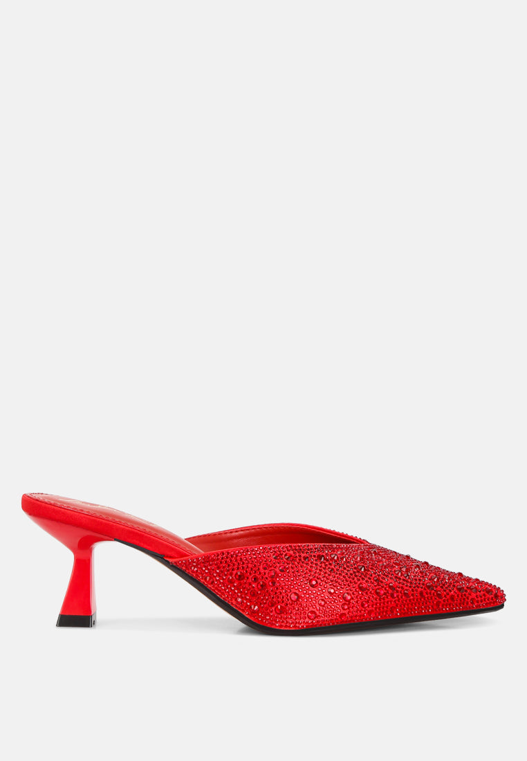 Red high-heeled shoe with rhinestone embellishments on a white background