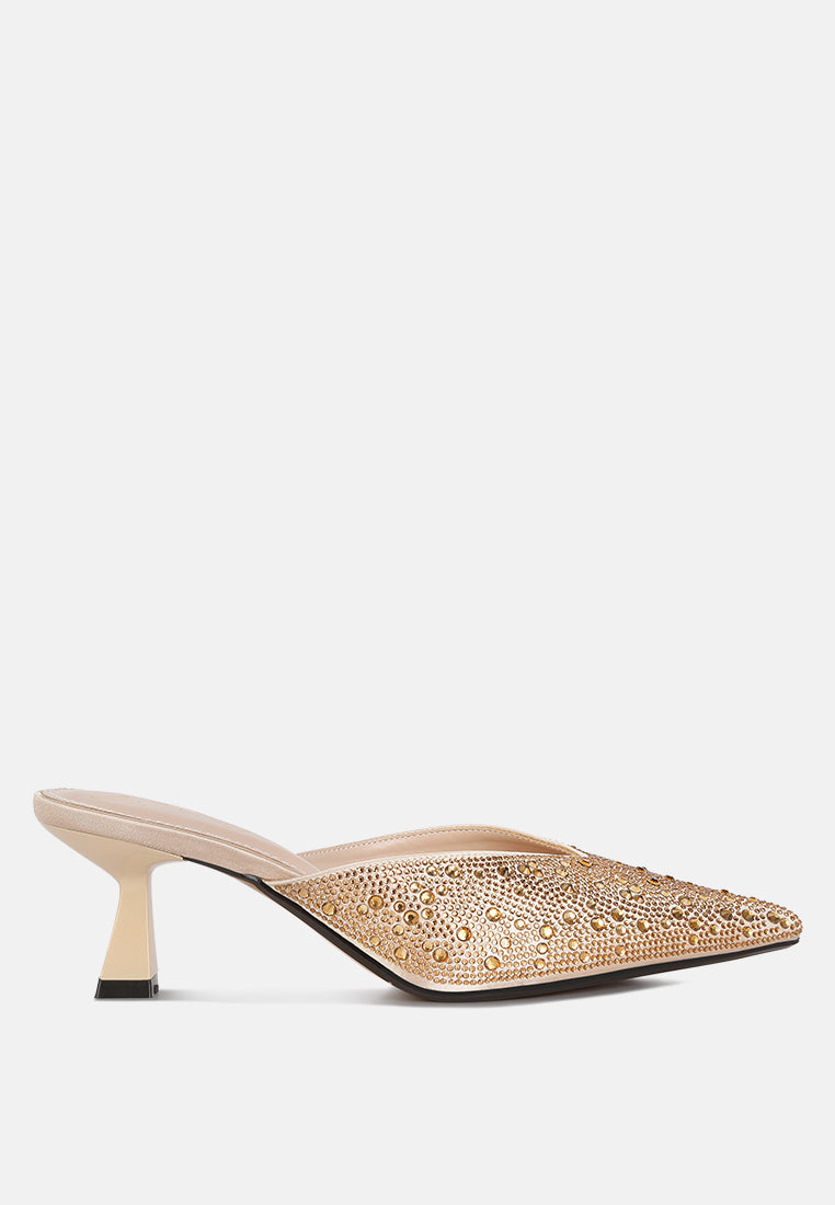Beige high-heeled shoe with intricate detailing on a white background