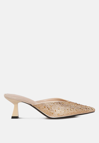 Beige high-heeled shoe with intricate detailing on a white background