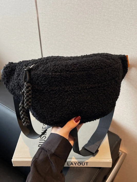 Black textured bag held by a hand on a magazine with 'Disney' branding.