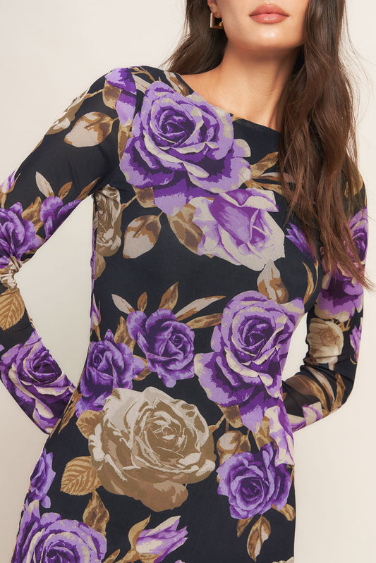 Black dress with purple and gold floral pattern worn by a model