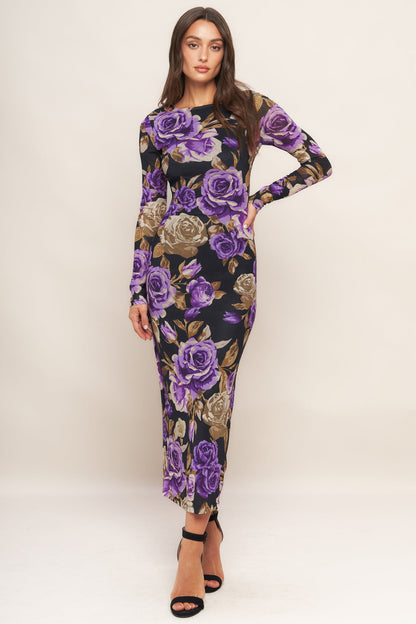Woman wearing a floral dress with purple roses on a white background