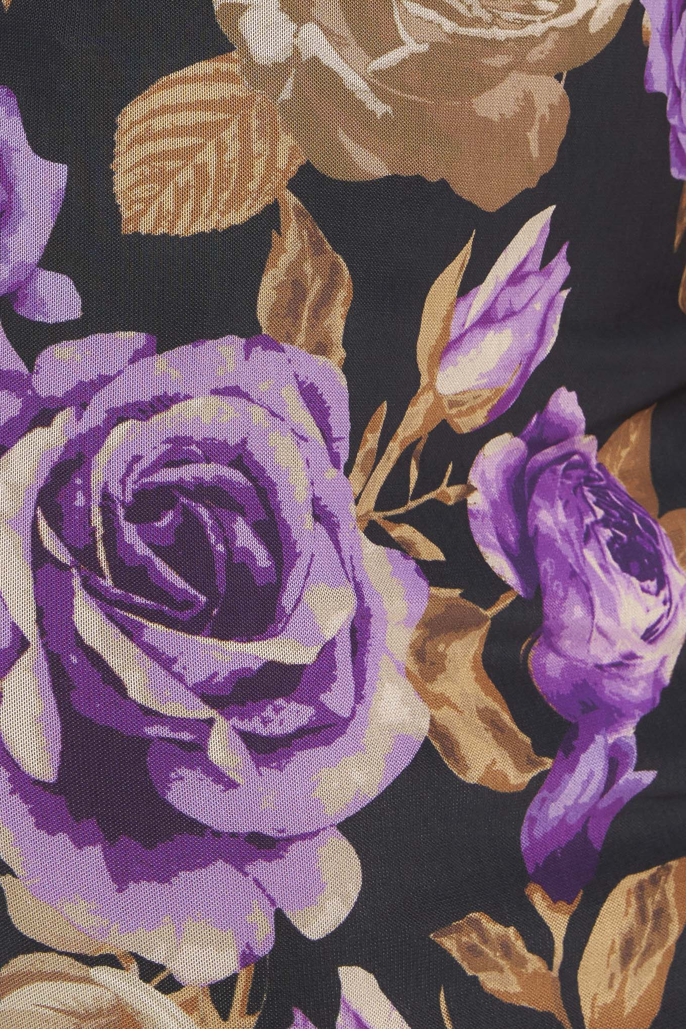 Close-up of purple and gold floral pattern on a dark background