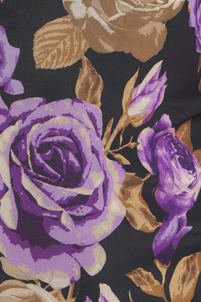 Close-up of purple and gold floral pattern on a dark background